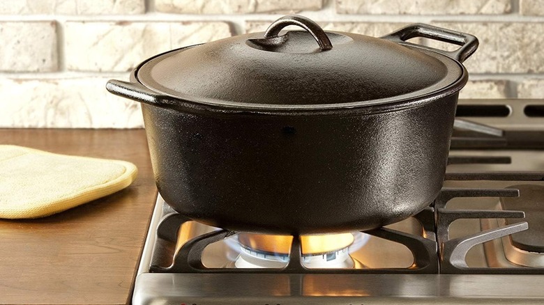A Lodge BOLD Premium Campfire Cast Iron Dutch Oven on a stovetop