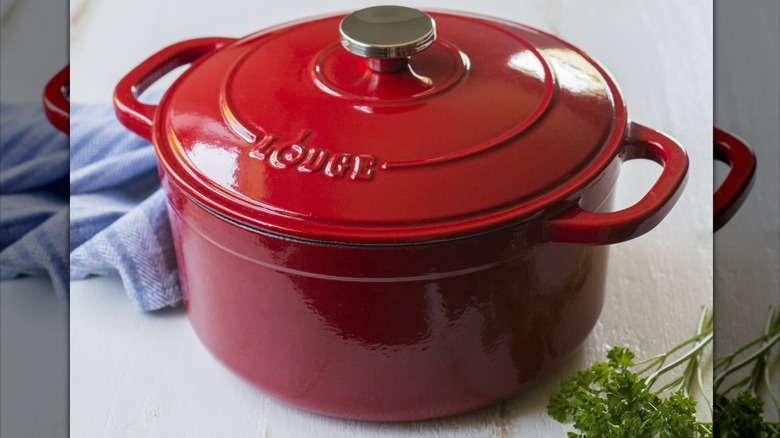 A red Lodge Enameled Cast Iron Dutch Oven on a kitchen counter