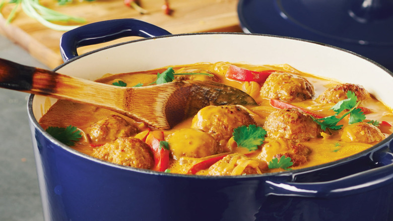 Meatball soup served in a deep blue Tramontina Bestow Enameled Cast Iron Round Dutch Oven