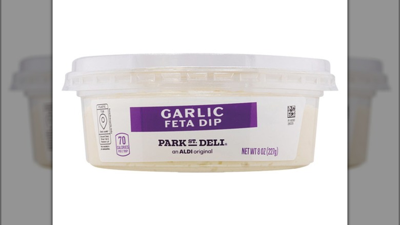A container of Park Street Deli Garlic Feta Dip from Aldi is on a white background.