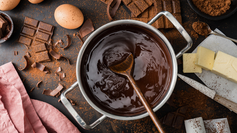 scattered baking ingredients for chocolate pie including butter and eggs