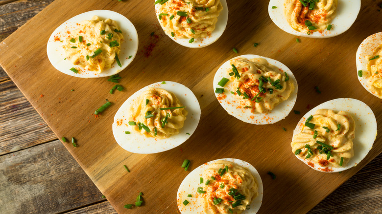 Top view of deviled eggs with paprika and chives