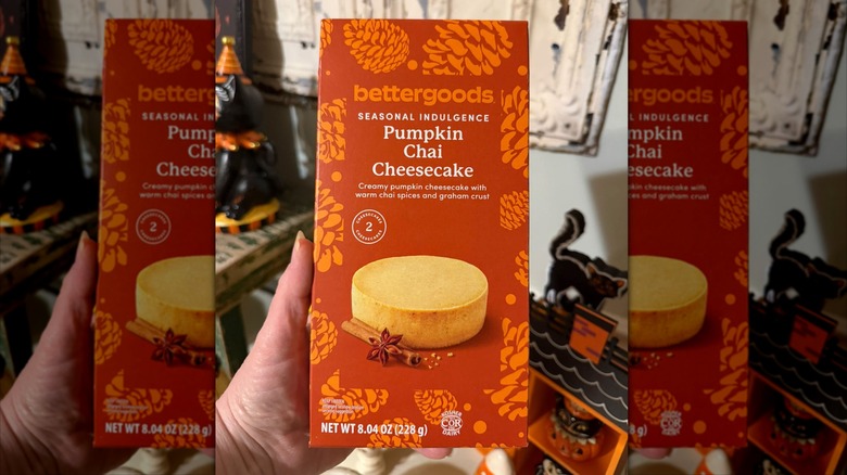 Hand holding a box of Bettergoods Pumpkin Chai Cheesecake