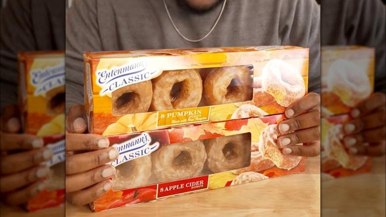 Hand holding the Entenmann's Pumpkin Spice Donuts box
