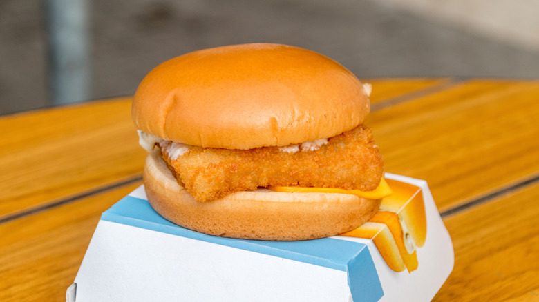 A Filet-O-Fish sits atop its box on a well-lit table