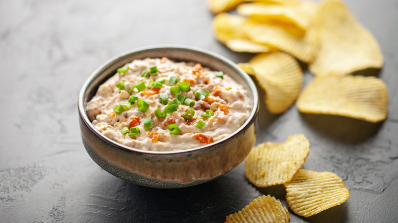 A bowl of French onion dip and chips