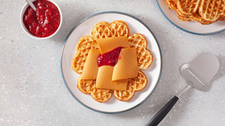 Norwegian waffles topped with brunost and raspberry jam.