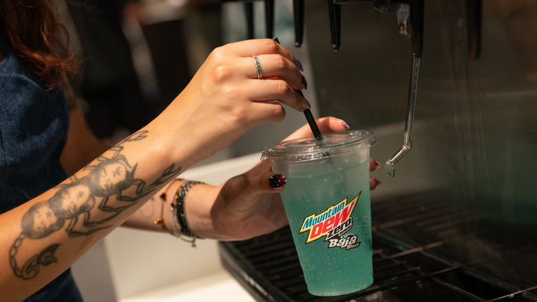 Taco Bell customer filling up a cup of Mountain Dew Baja Blast