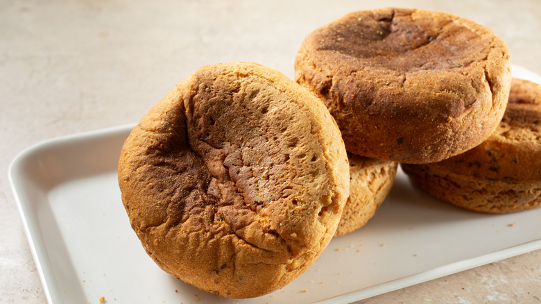 Pile of English muffins on plate