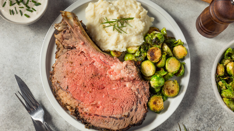 Overhead view of prime rib and vegetables on a plate