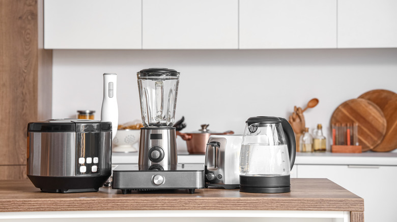 Set of appliances on wooden table in contemporary kitchen
