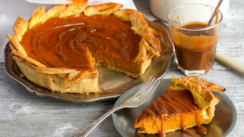A delicious, homemade pumpkin pie drizzled in caramel sauce