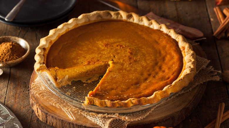 pumpkin pie with slice cut out