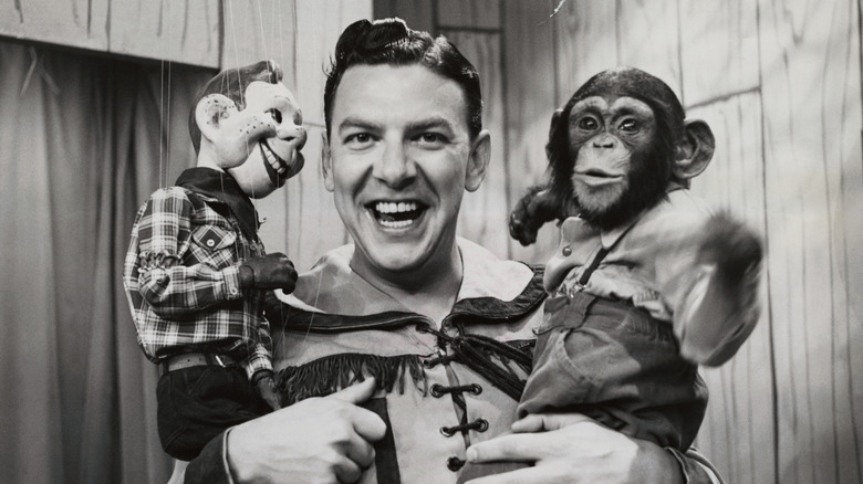 Buffalo Bob Smith holding Howdy Doody ventriloquist dummy and chimp
