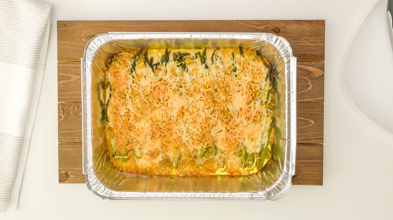 Cheesy asparagus casserole in a foil baking tray