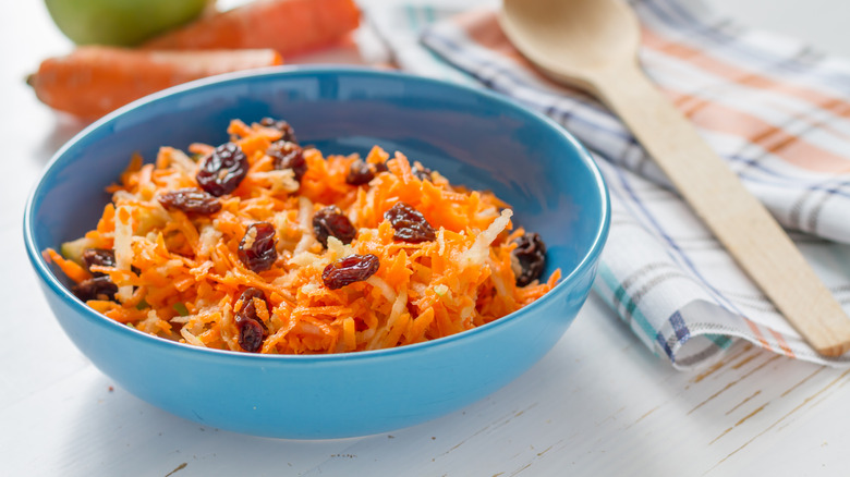 Bowl of shredded carrot raisin salad