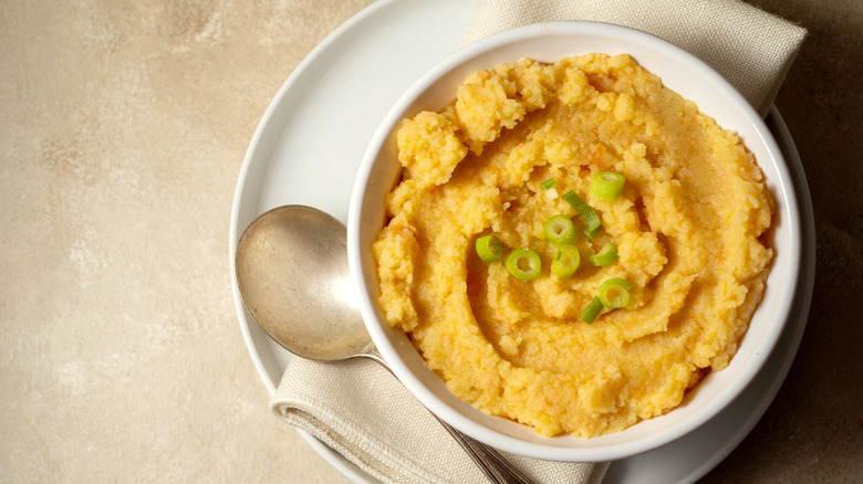 Bowl of mashed turnips garnished with chopped green onion