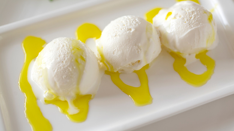 Vanilla ice cream with a yellow sauce on a plate