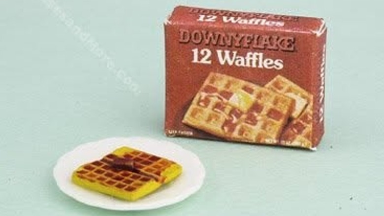 A box of Downyflake Waffles and plate of waffles is shown on a blue background.