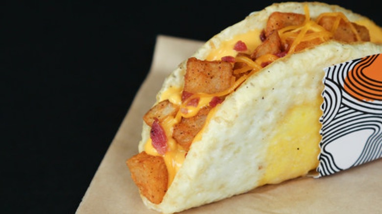 Taco Bell Naked Egg Taco which is a folded, fried egg stuffed with potatoes, cheese, and bacon