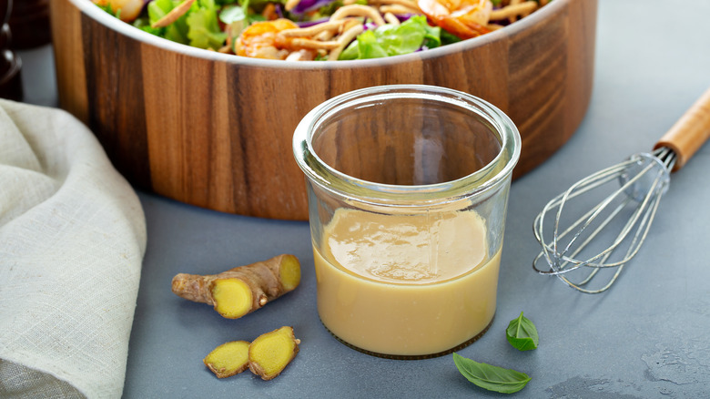 salad dressing in cup with whisk