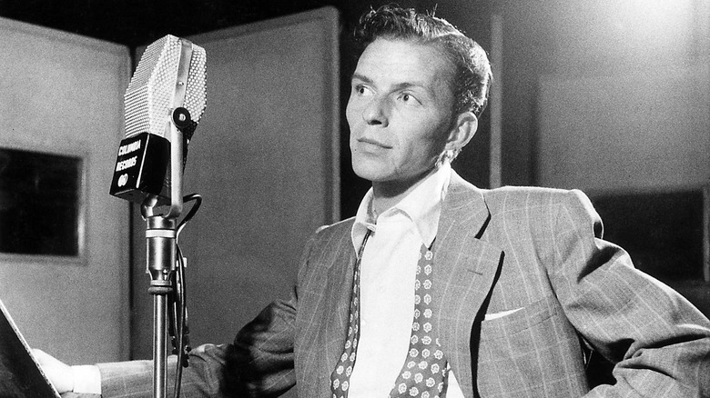 Frank Sinatra standing at microphone