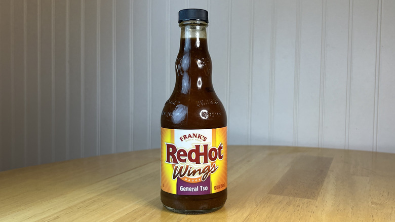 Bottle of Frank's RedHot General Tso Sauce on wooden table