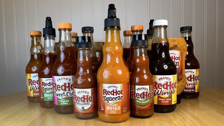 Assorted bottles of Frank's RedHot Sauce on kitchen table