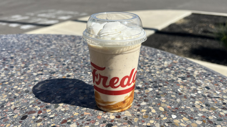 Freddy's Cold Brew Caramel Crunch Concrete on an outside table