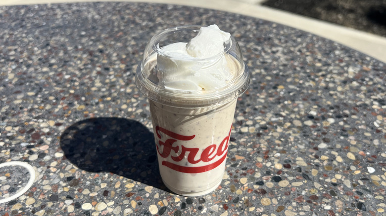Freddy's Reese's Royale Concrete on an outside table