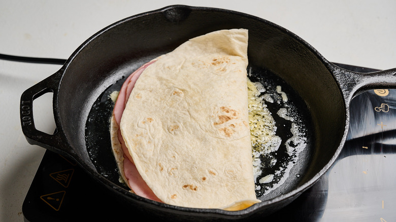 quesadilla cooking in a skillet
