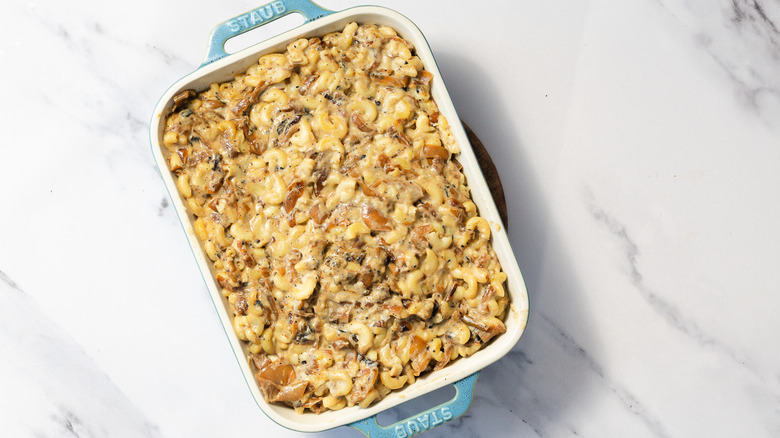 Unbaked mac and cheese in blue casserole dish