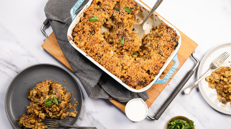 A casserole dish and a serving of French onion mac and cheese