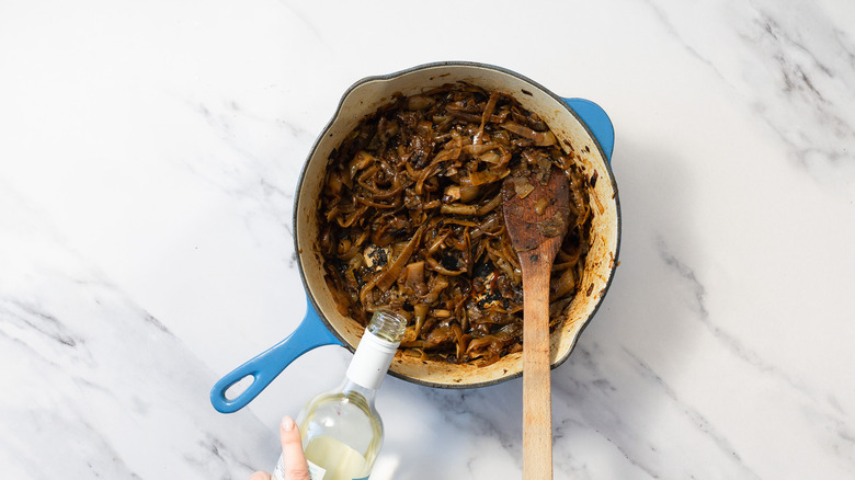 Adding wine to cooked onions in stock