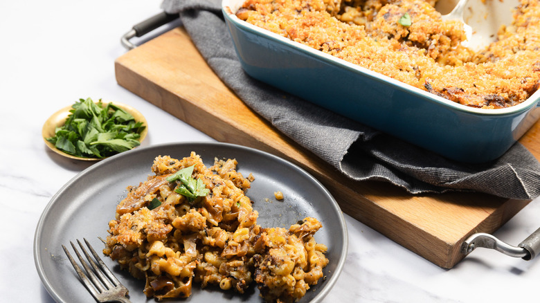 A casserole dish and a serving of French onion mac and cheese