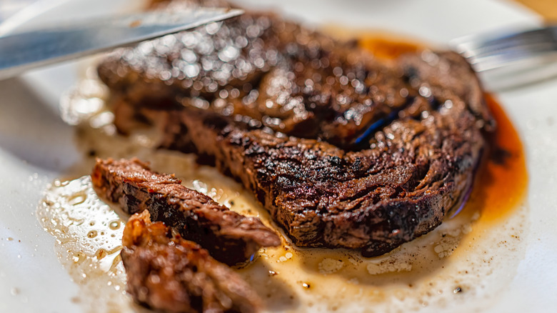 A close up of an overcooked steak