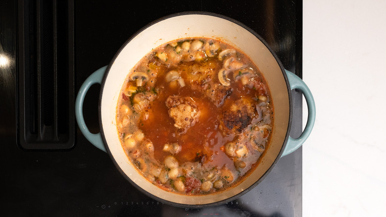 chicken chasseur cooking in pan