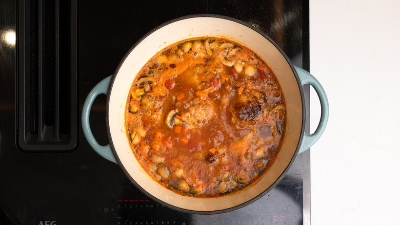 chicken chasseur simmering on hob