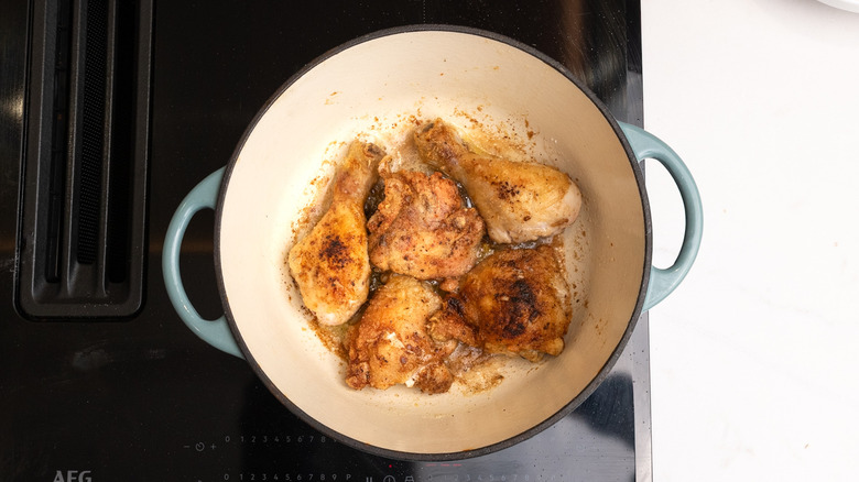 chicken frying in a pan