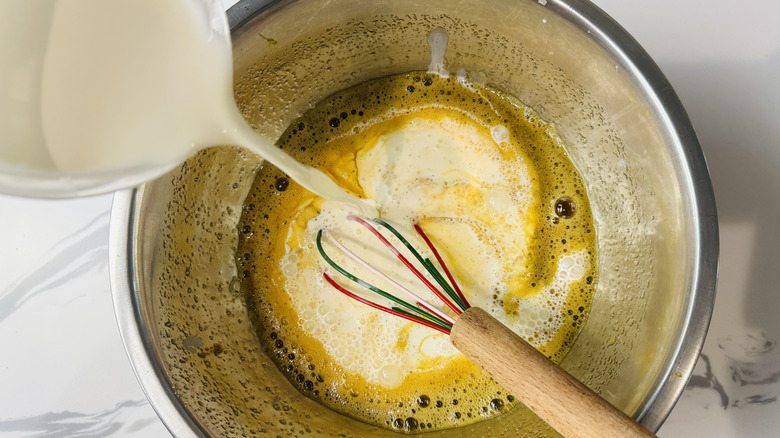 Whisking half-and-half into custard