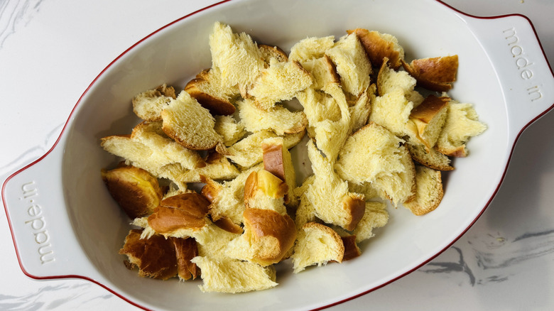 Ripped challah bread in baking dish