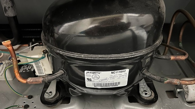 An image of a compressor installed in a Whirlpool refrigertor
