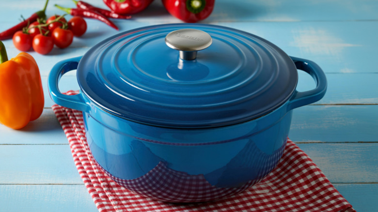 Blue dutch oven set on a red gingham cloth