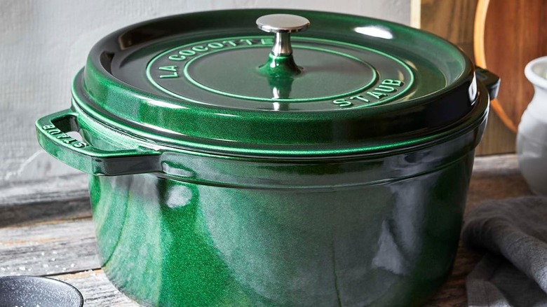 Close-up product image of the green, round Staub La Cocotte Dutch oven