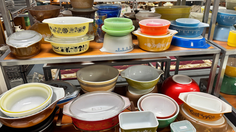 assortment of vintage Pyrex dishes on display at a thrift store