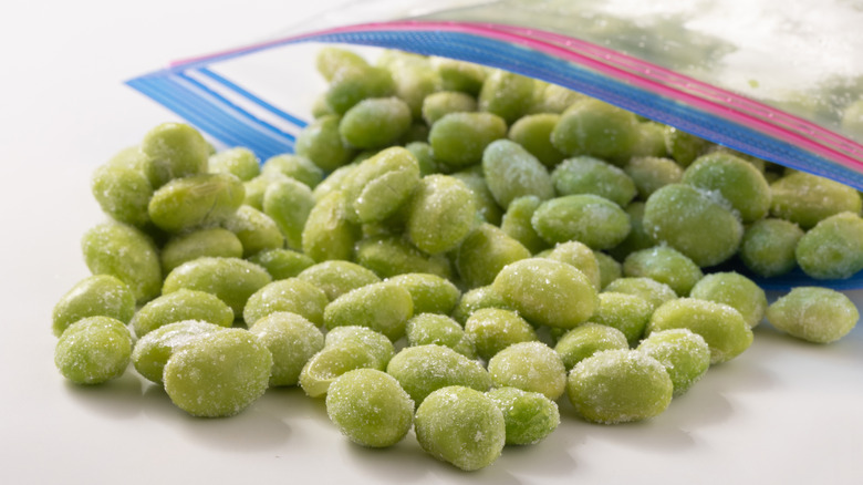 Shelled, frozen edamame spilling out of plastic bag