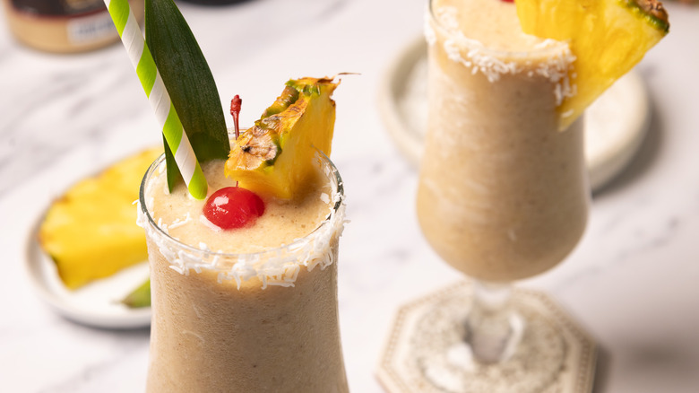 Two hummingbird cocktails with toppings.