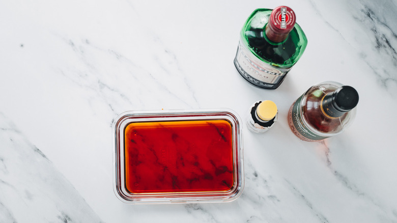 Liquid ingredients for Manhattan cocktail in a glass container.