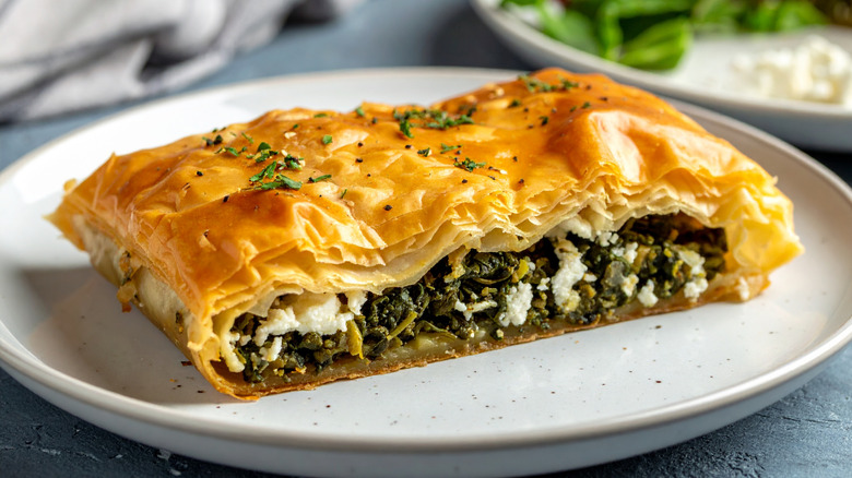 close up of spanakopita slice on plate