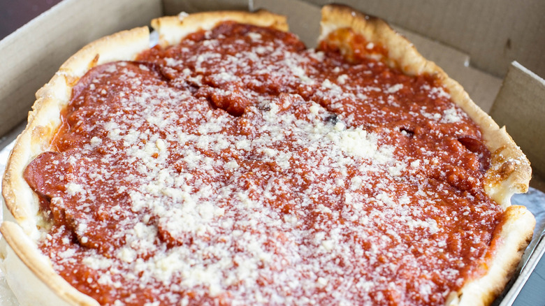 A deep dish pizza topped with cheese